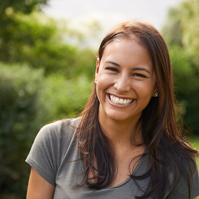 The image shows a modern office space with a blue wall, a white ceiling, two spherical light fixtures, and a company logo on the wall.